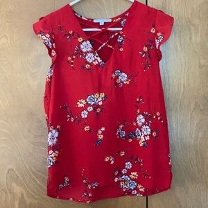 woman’s red floral flutter sleeved blouse.